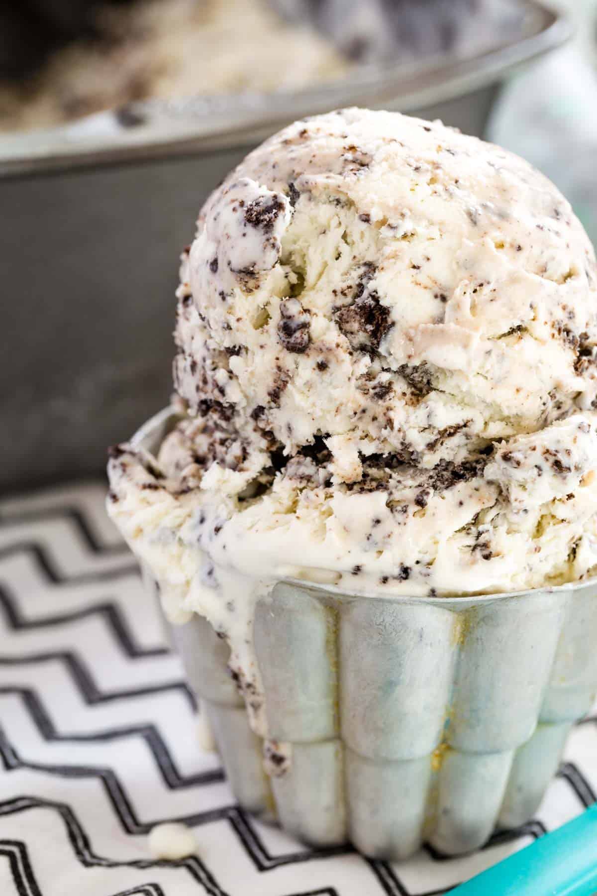 A scoop of cookies and cream ice cream in a bowl.