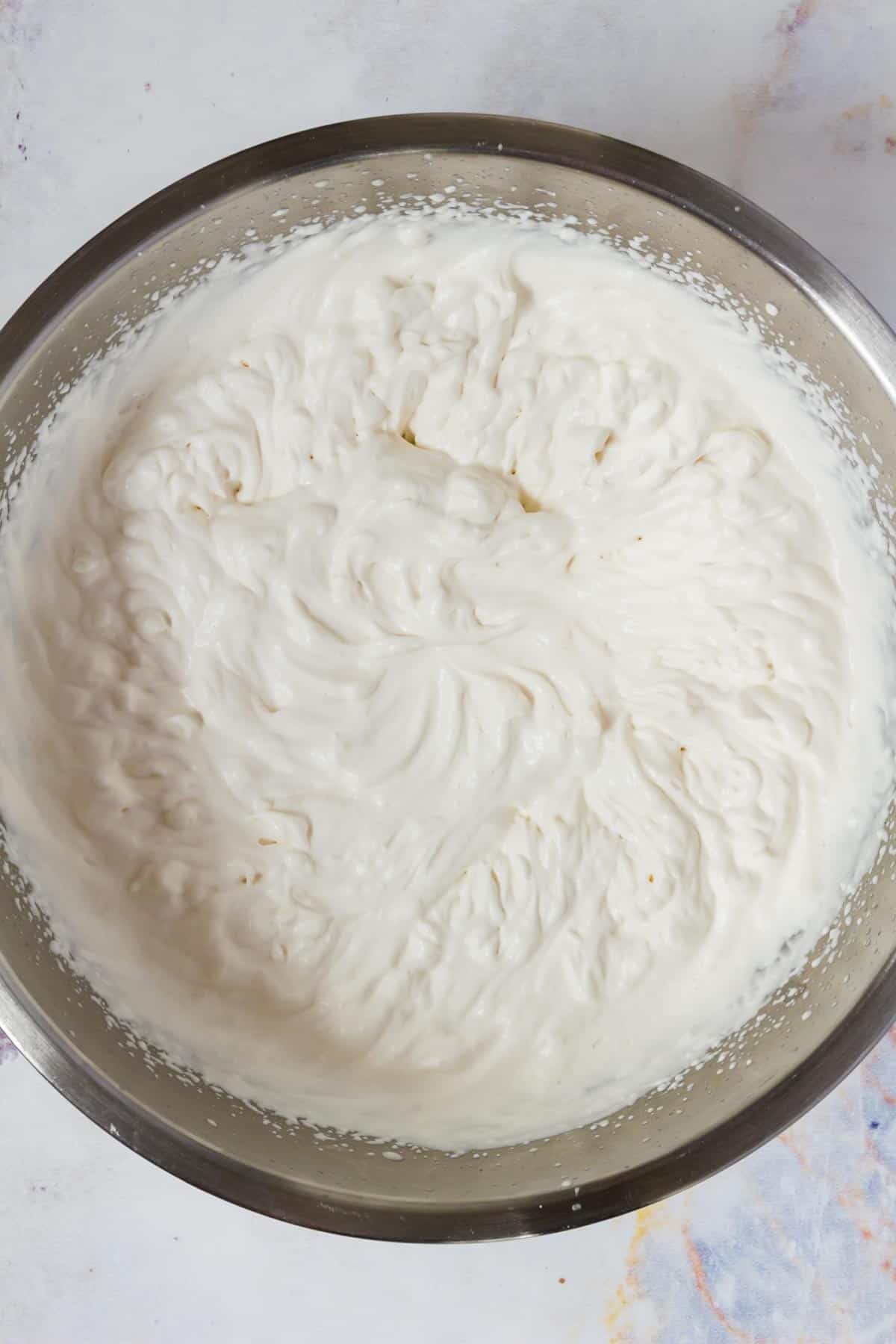 Whipping cream in a chilled mixing bowl.