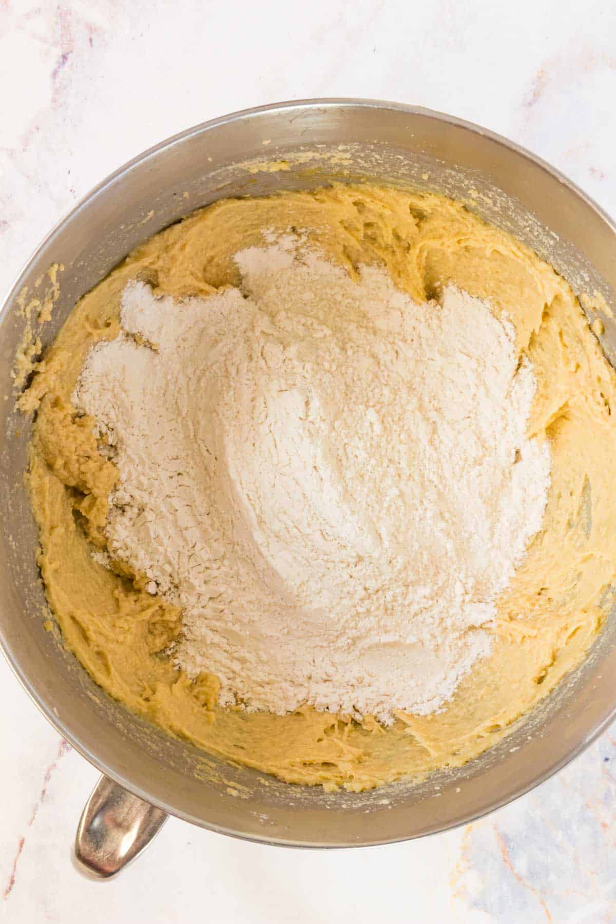 Flour is added into the wet ingredients for gluten-free cookie dough.