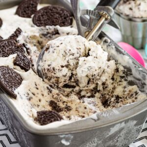 A scoop in a container of cookies and cream ice cream.