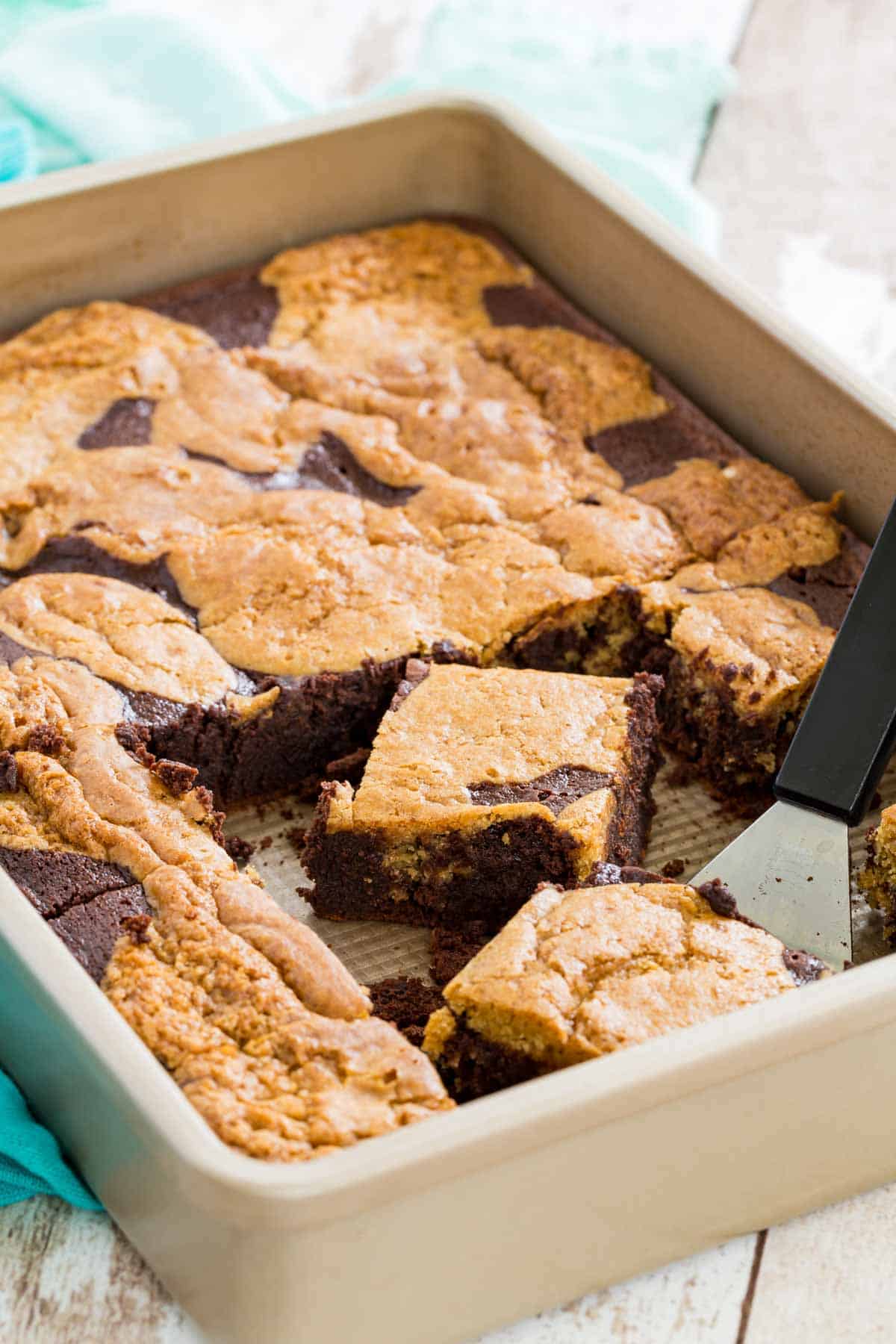 A metal baking pan filled with brookies cut into squares.