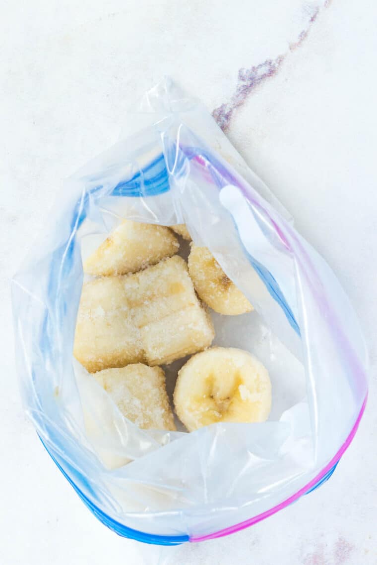 A plastic baggie full of banana slices sitting on a countertop