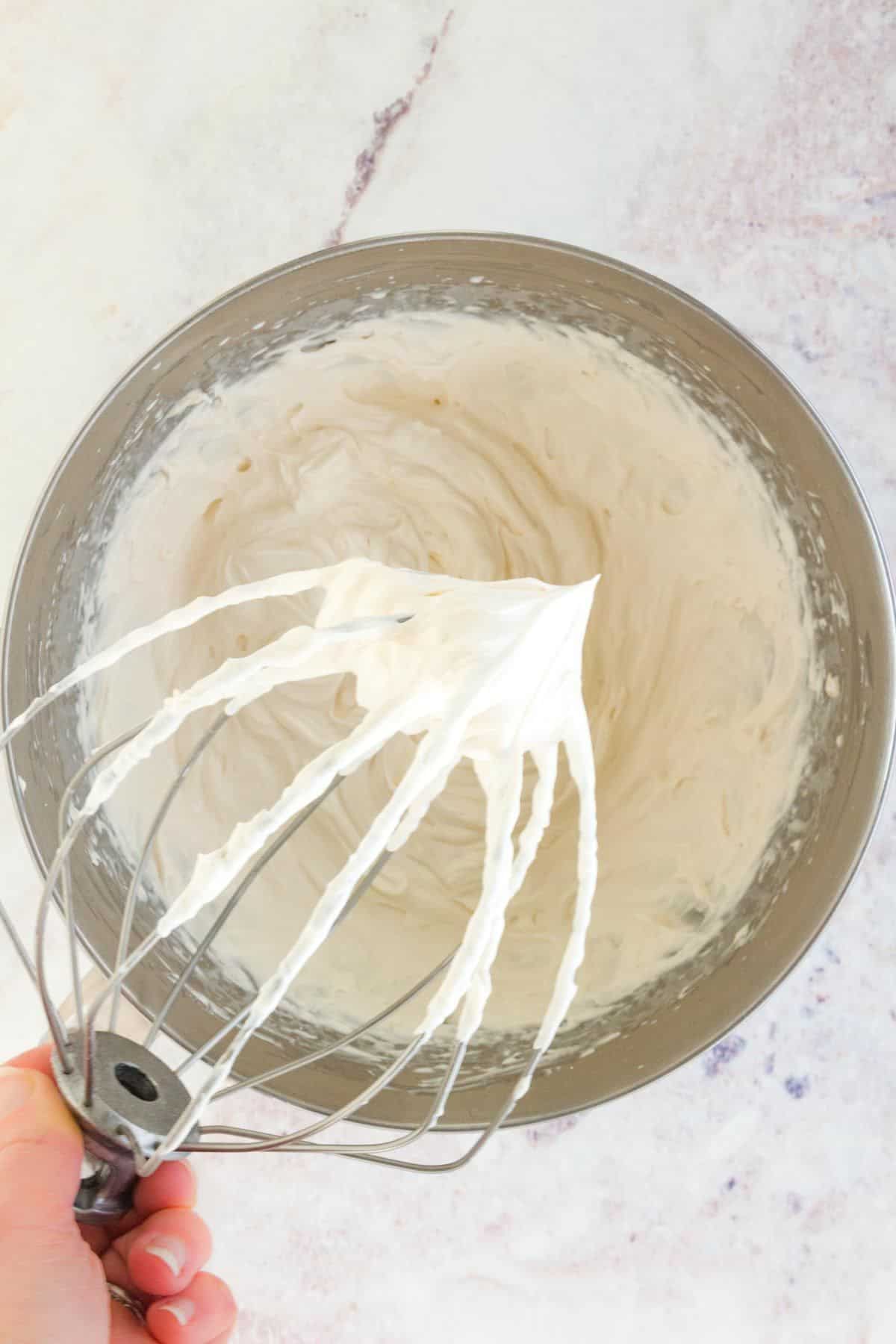 The finished whipped cream frosting showing stiff peaks