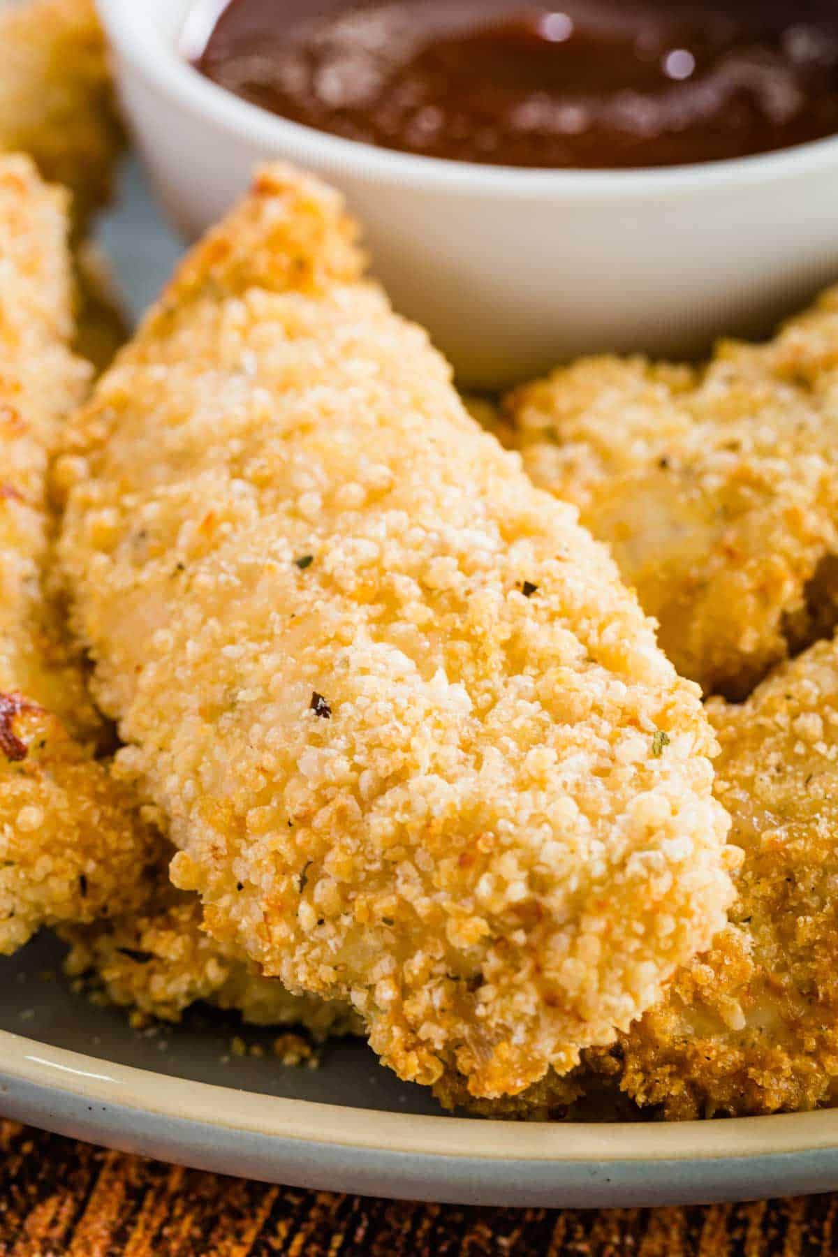Close up of baked chicken tenders on a plate.