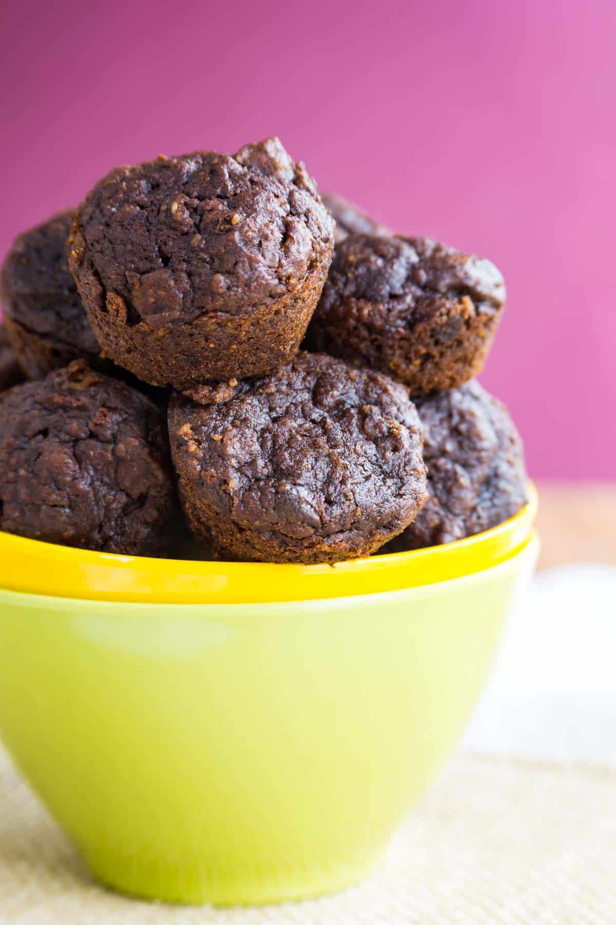 A close-up of a bowl piled high with Flourless Nutella Pumpkin Muffins.