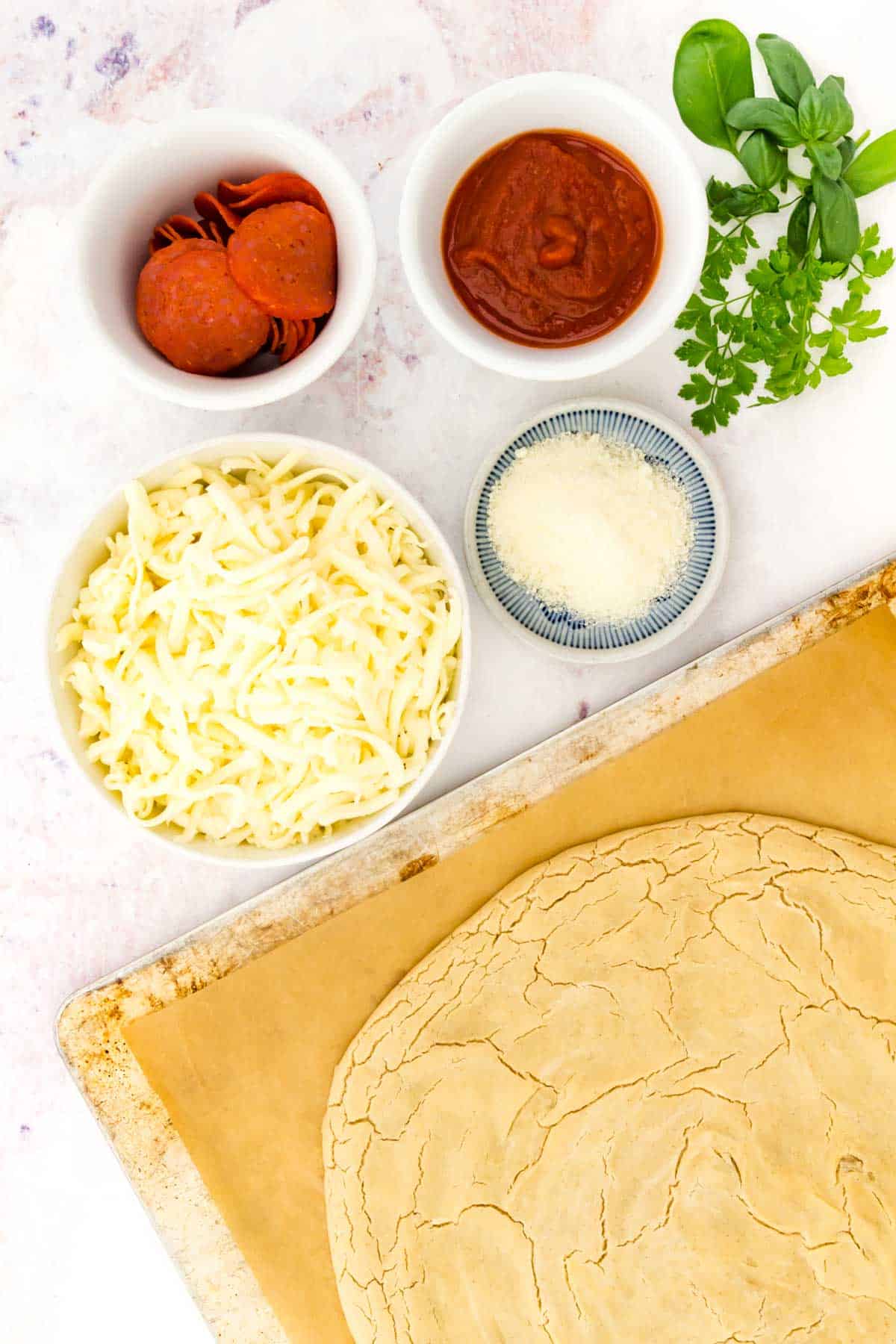 The ingredients for homemade gluten free pepperoni pizza.