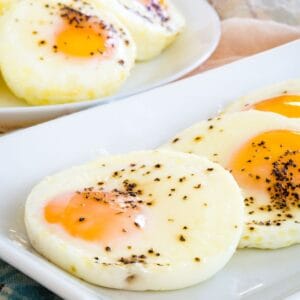 Baked eggs on white plates.
