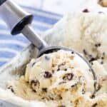 gluten free chocolate chip cookie dough ice cream being scooped out of a metal pan.