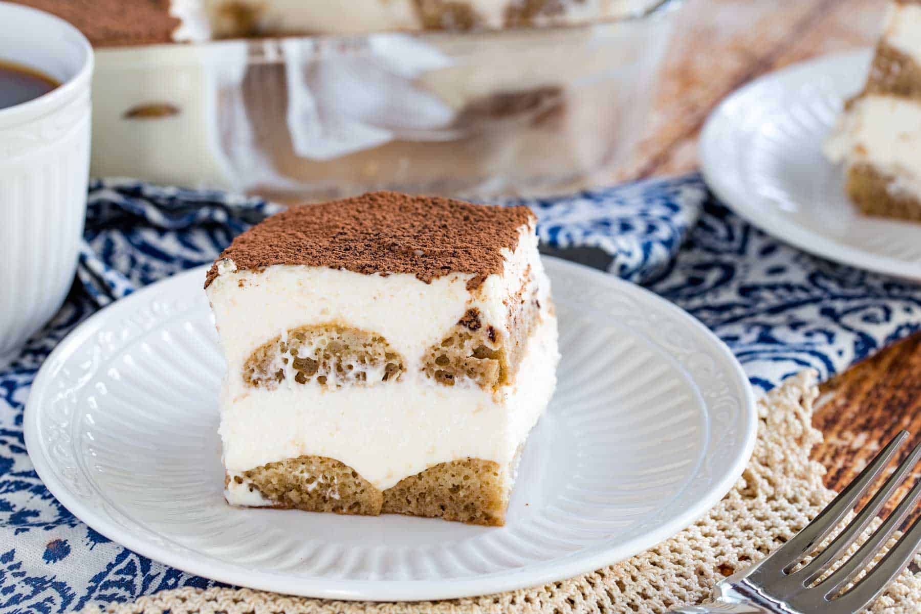 A slice of gluten-free tiramisu on a white plate.