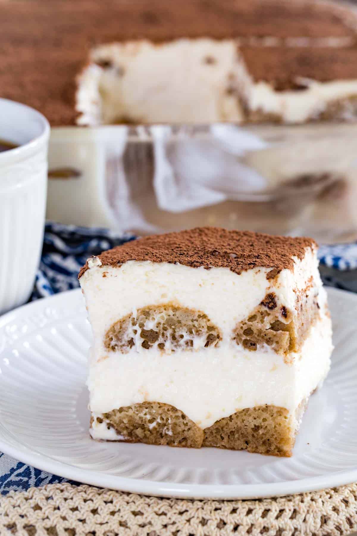 A slice of gluten-free tiramisu on a white plate.