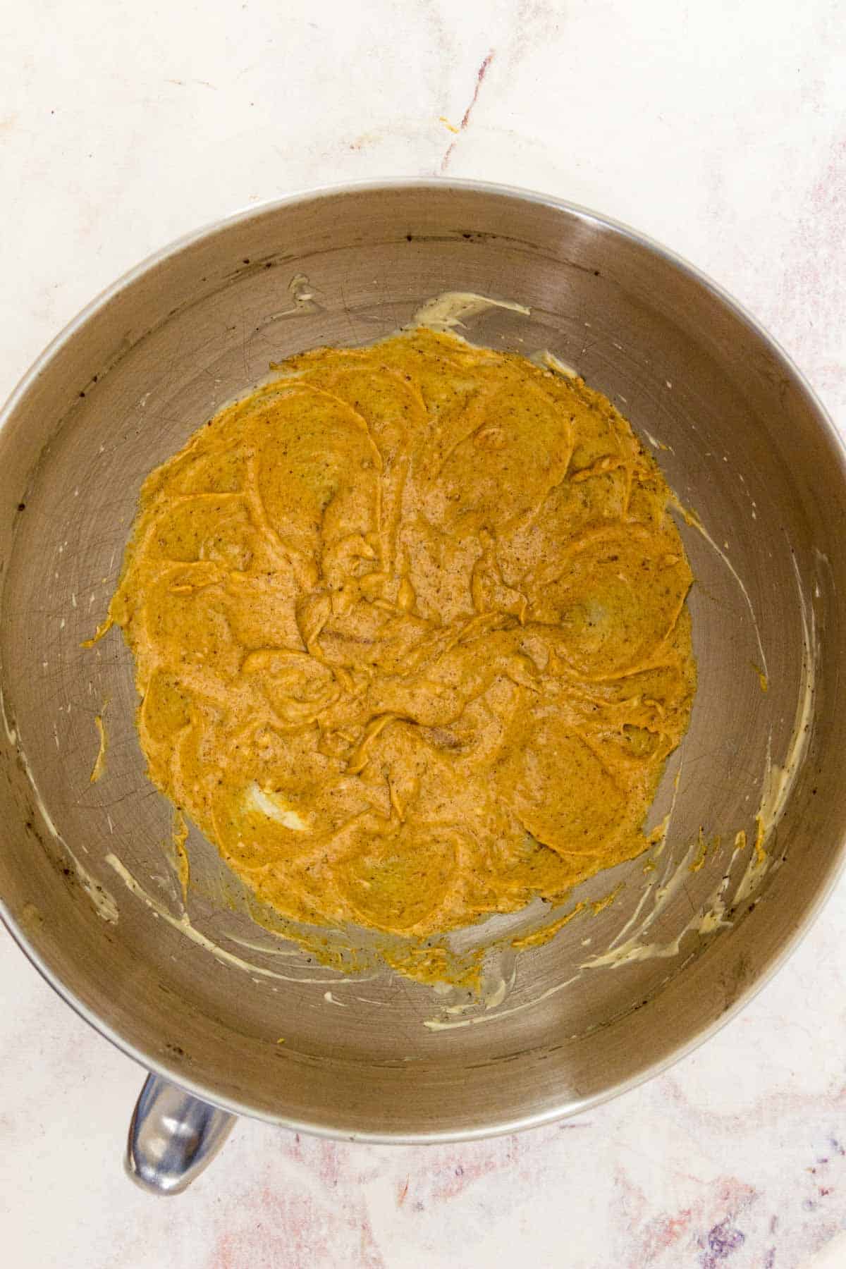 Butter, pumpkin, brown sugar and spices mixed together in a bowl.