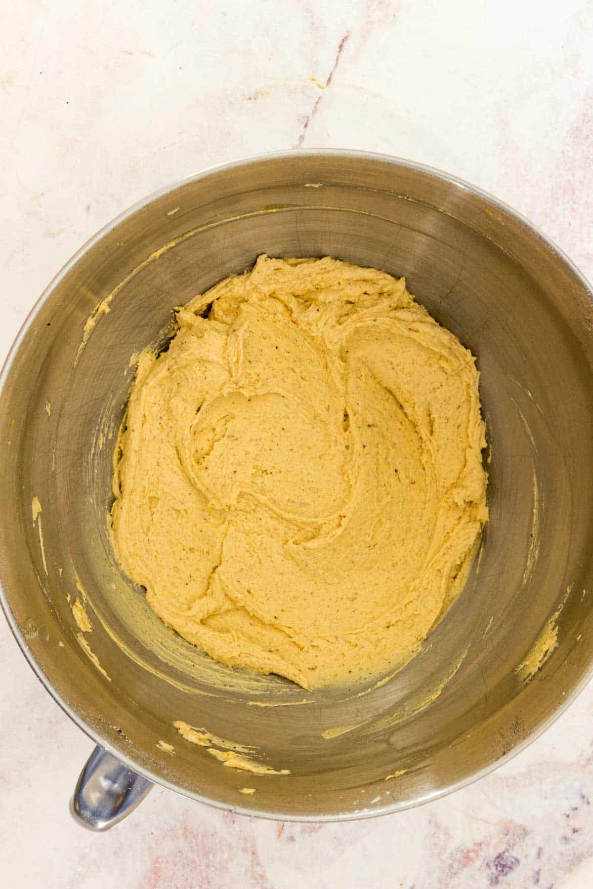 Pumpkin spice buttercream frosting in a mixing bowl.