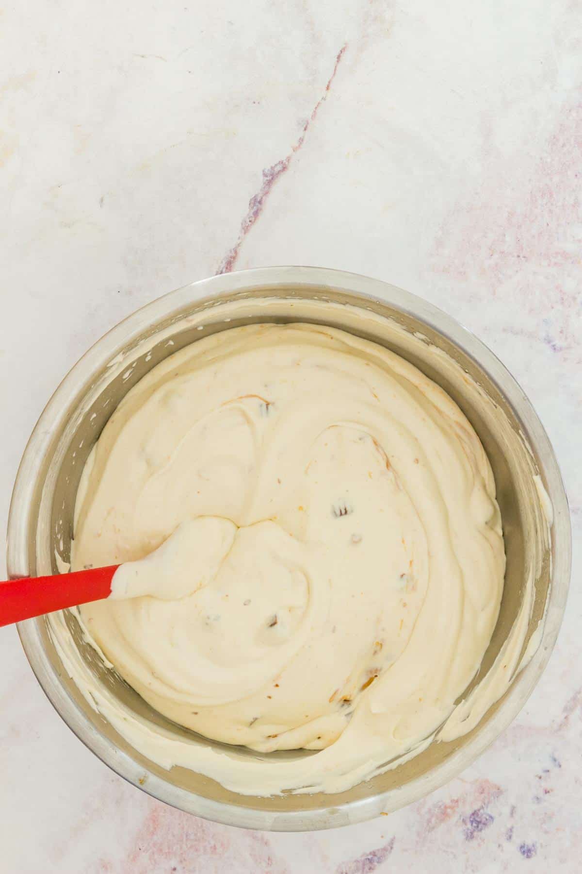 No-churn Reese's ice cream base in a large metal mixing bowl.