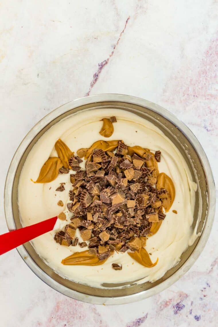 Peanut butter and chopped Reese's candy ready to be folded into an ice cream base.