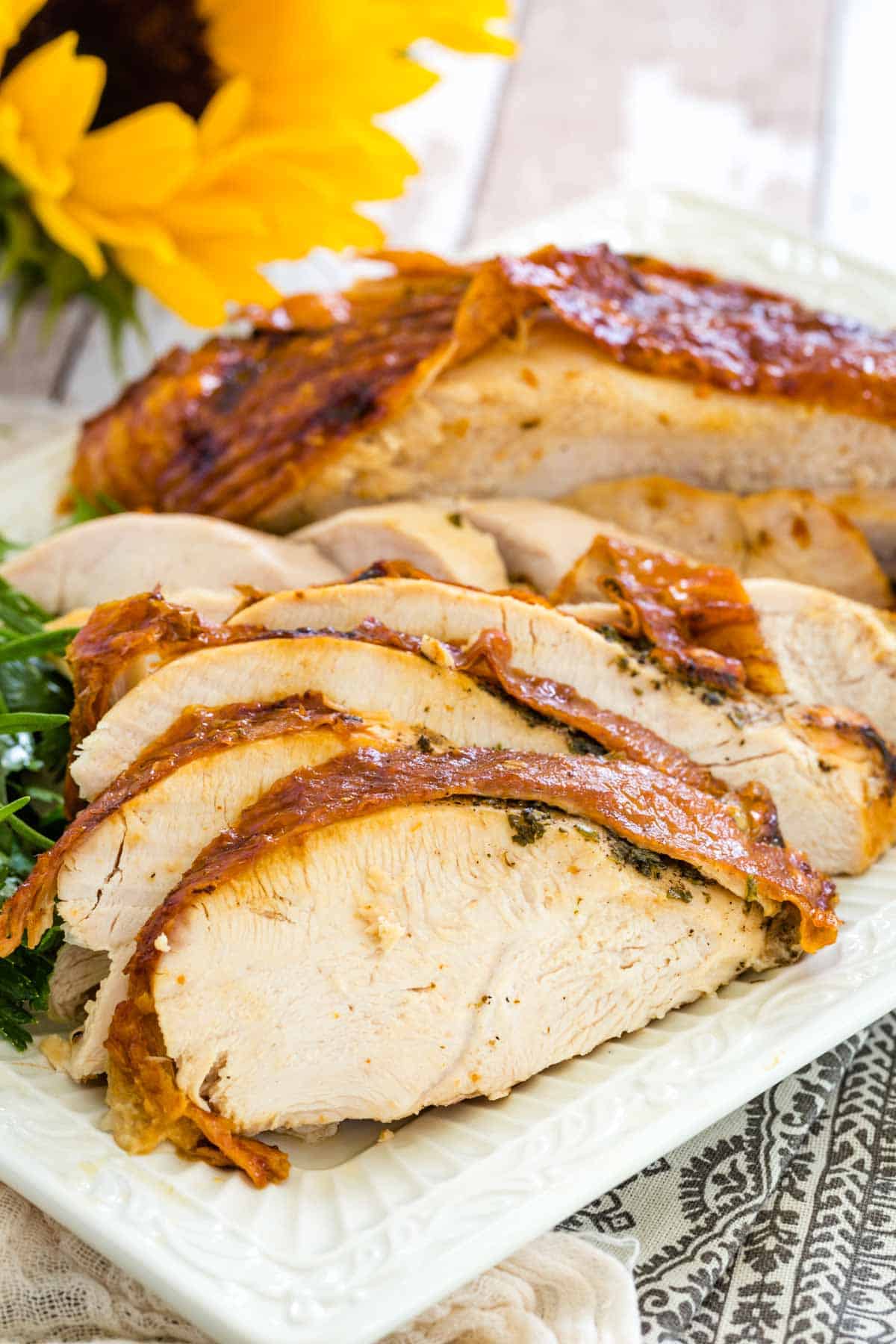 A carved air fryer turkey breast on a platter.