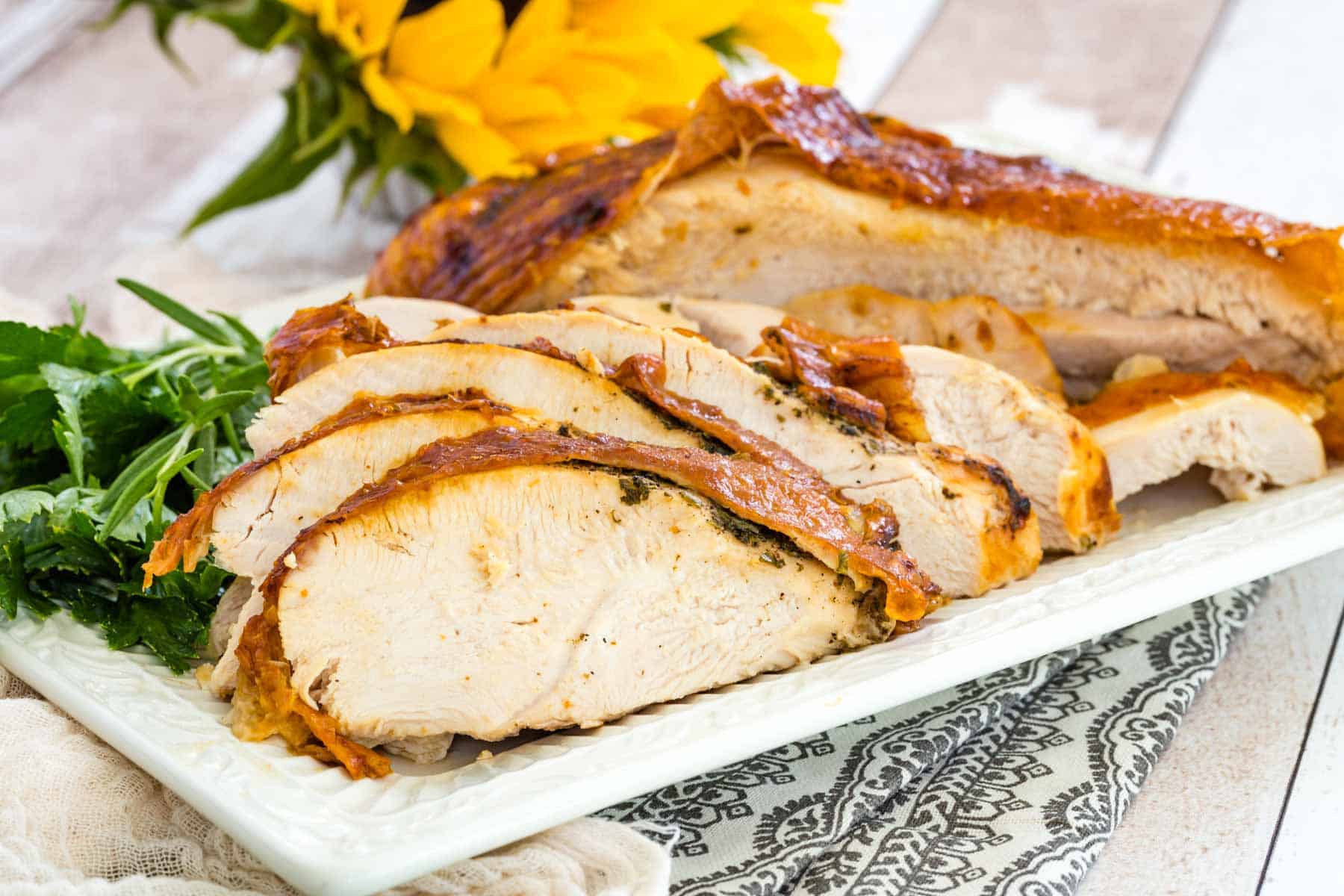 A carved air fryer turkey breast on a platter.