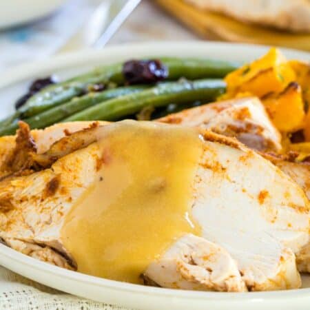 A close-up of a slice of turkey breast on a plate.