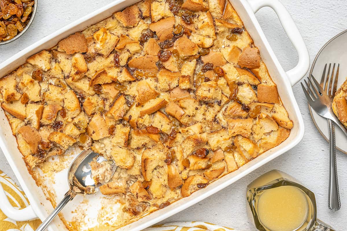 Gluten-free bread pudding in a baking dish with a serving missing.