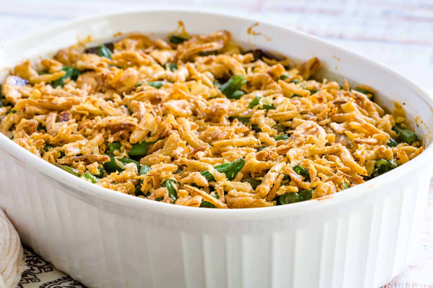 Gluten-free green bean casserole in a large white baking dish.