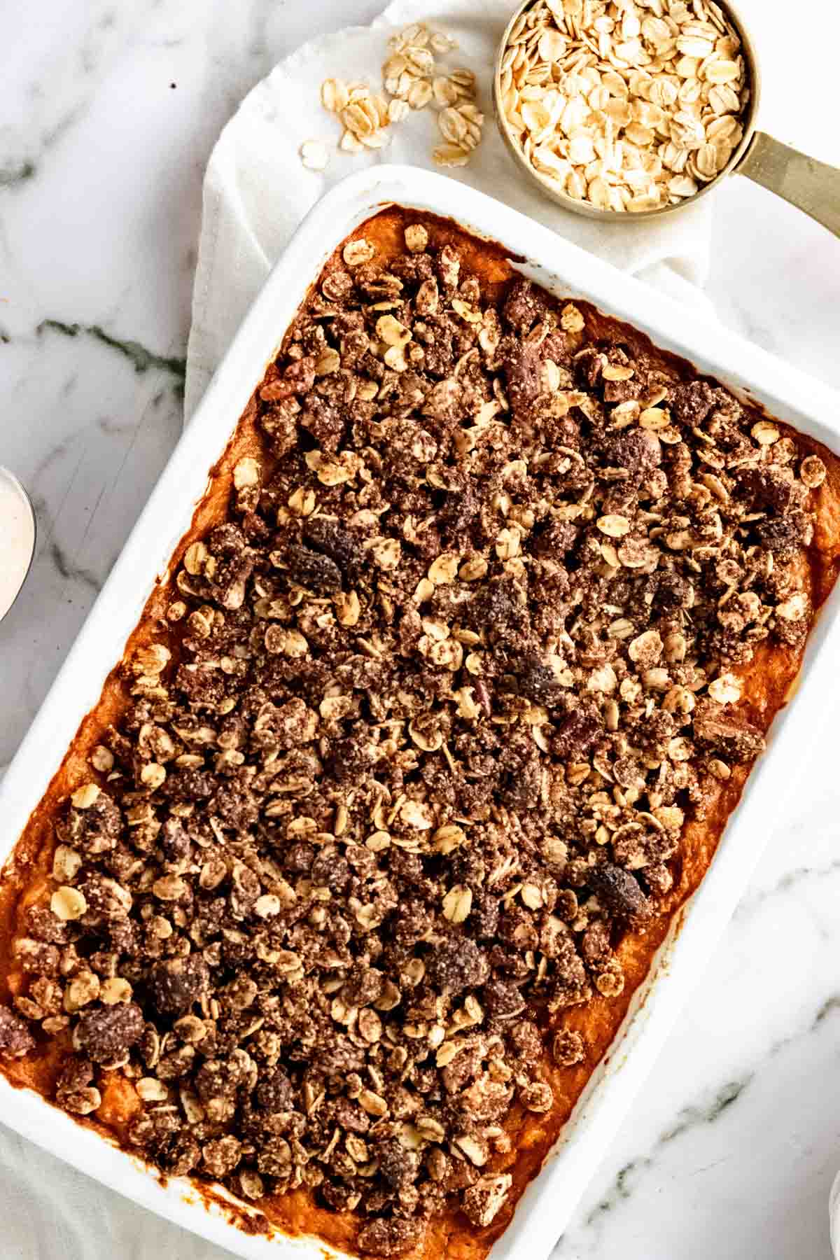 Overhead view of sweet potato casserole with a pecan oat topping.