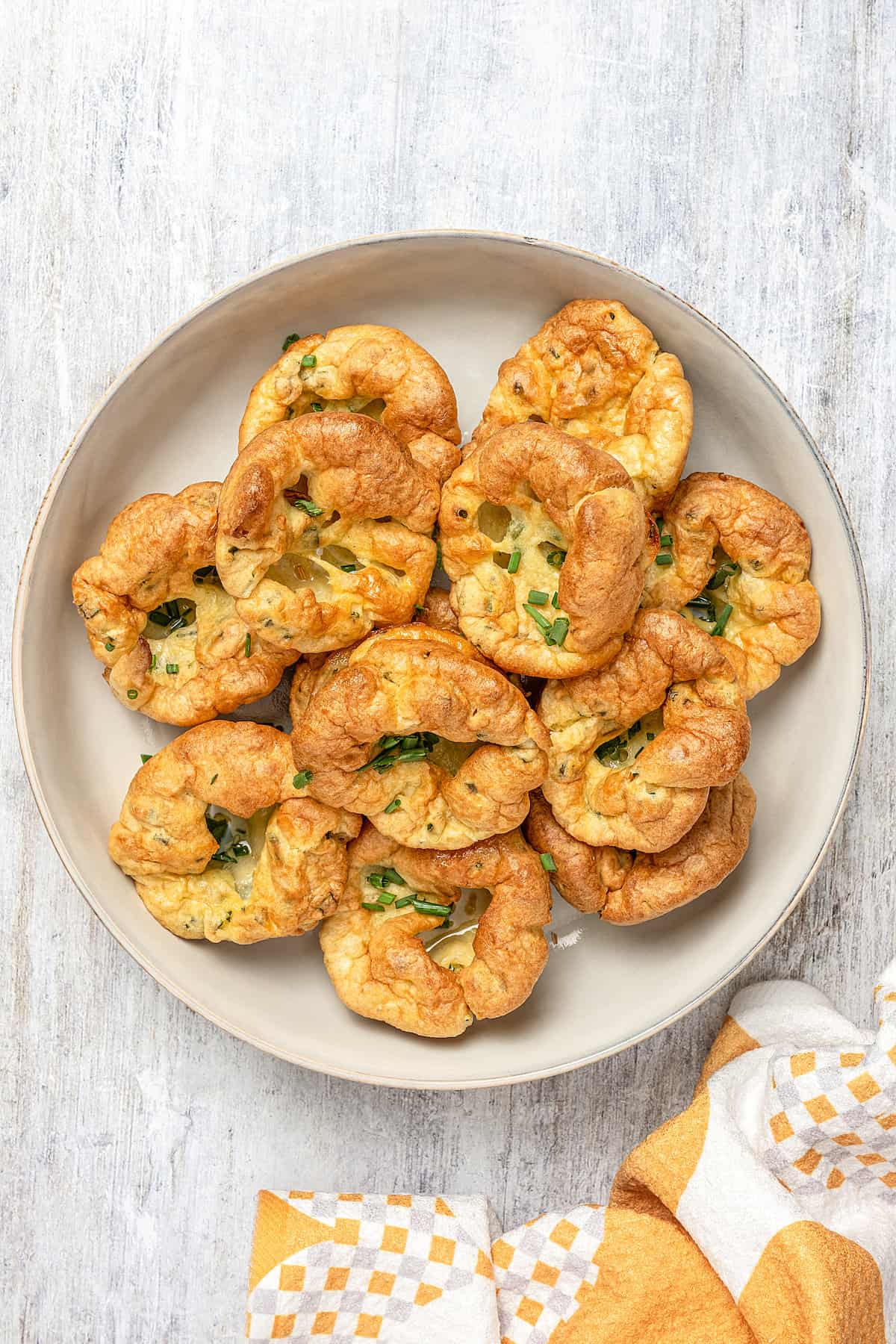 Top view of gluten-free Yorkshire pudding arranged on a serving plate.