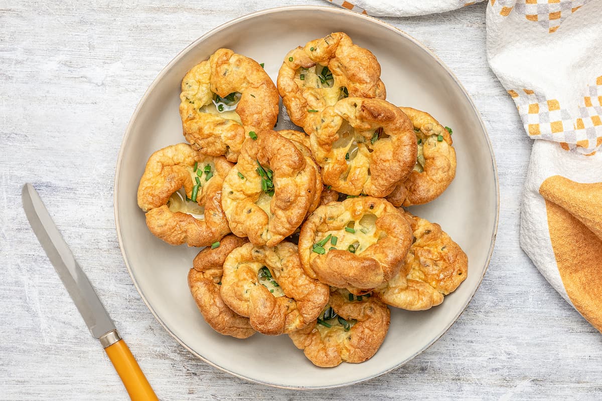 Top view of gluten-free Yorkshire pudding arranged on a serving plate.