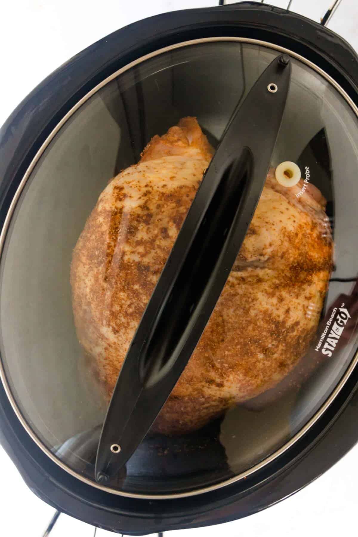 A turkey breast in the bottom of a Crock Pot.