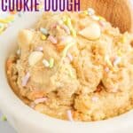 A bowl of birthday cake cookie dough with a wooden spoon with text overlay on the image.