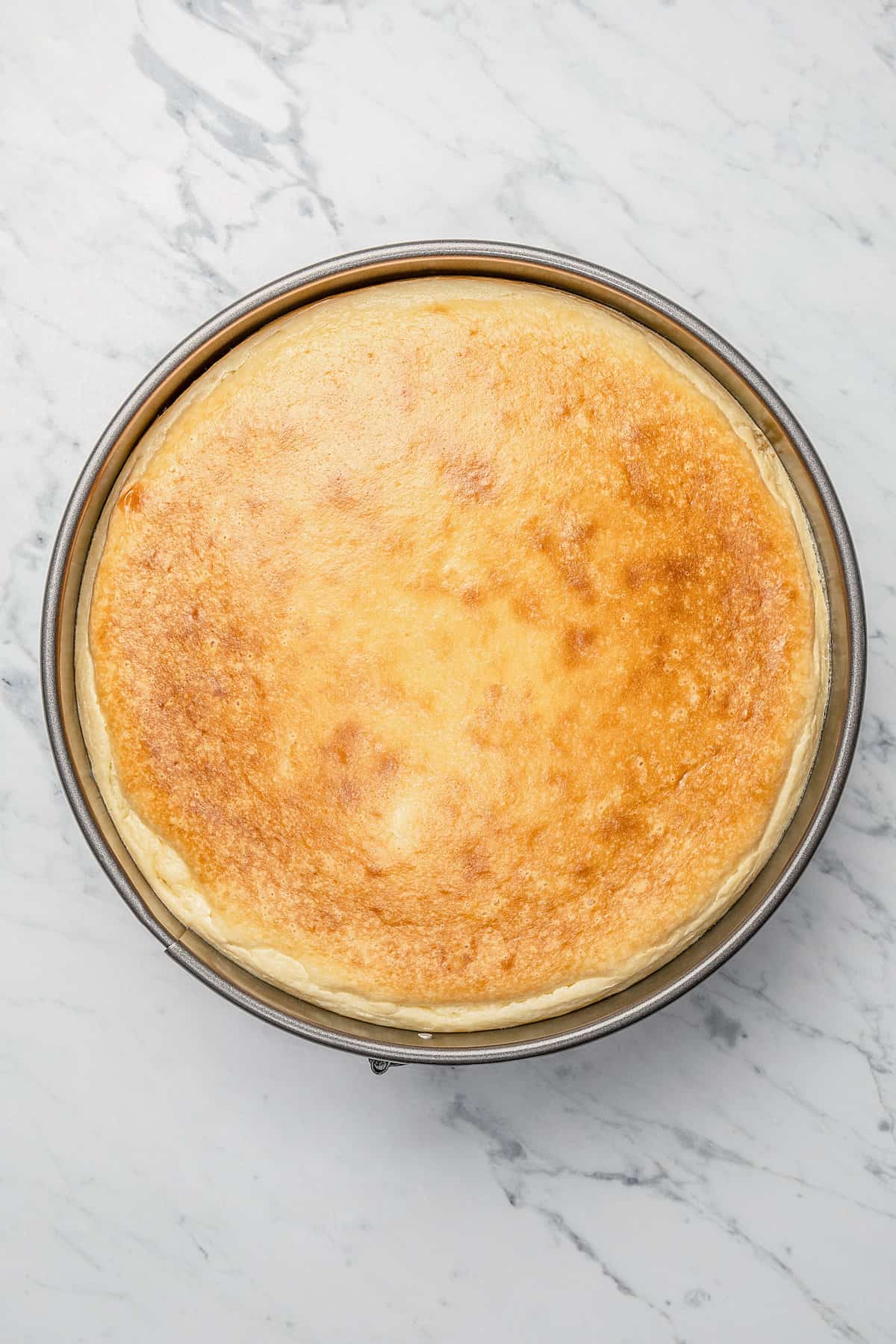 Baked cheesecake in a springform pan.