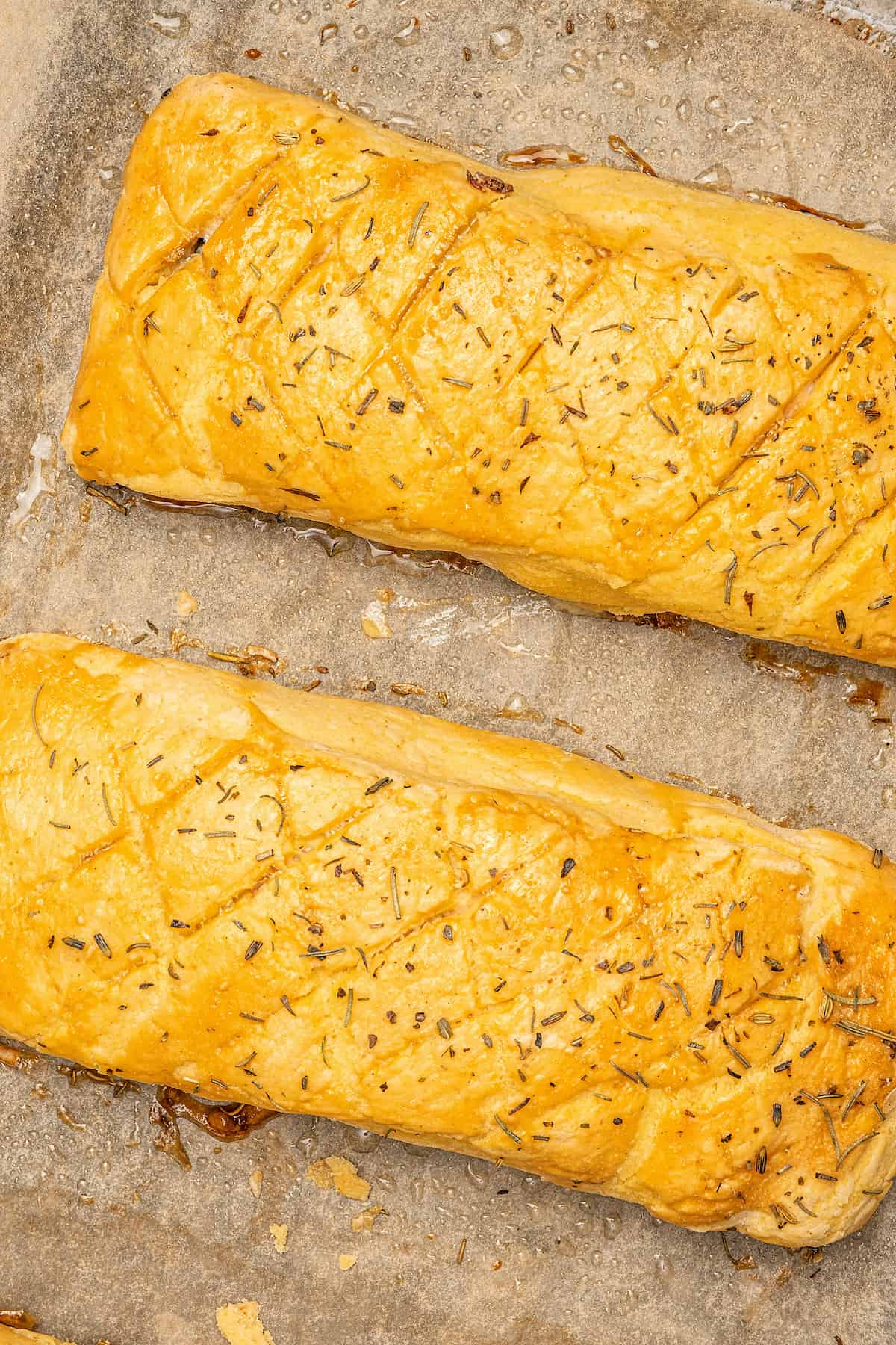 Baked gluten-free Salmon Wellingtons on a parchment-lined baking sheet.