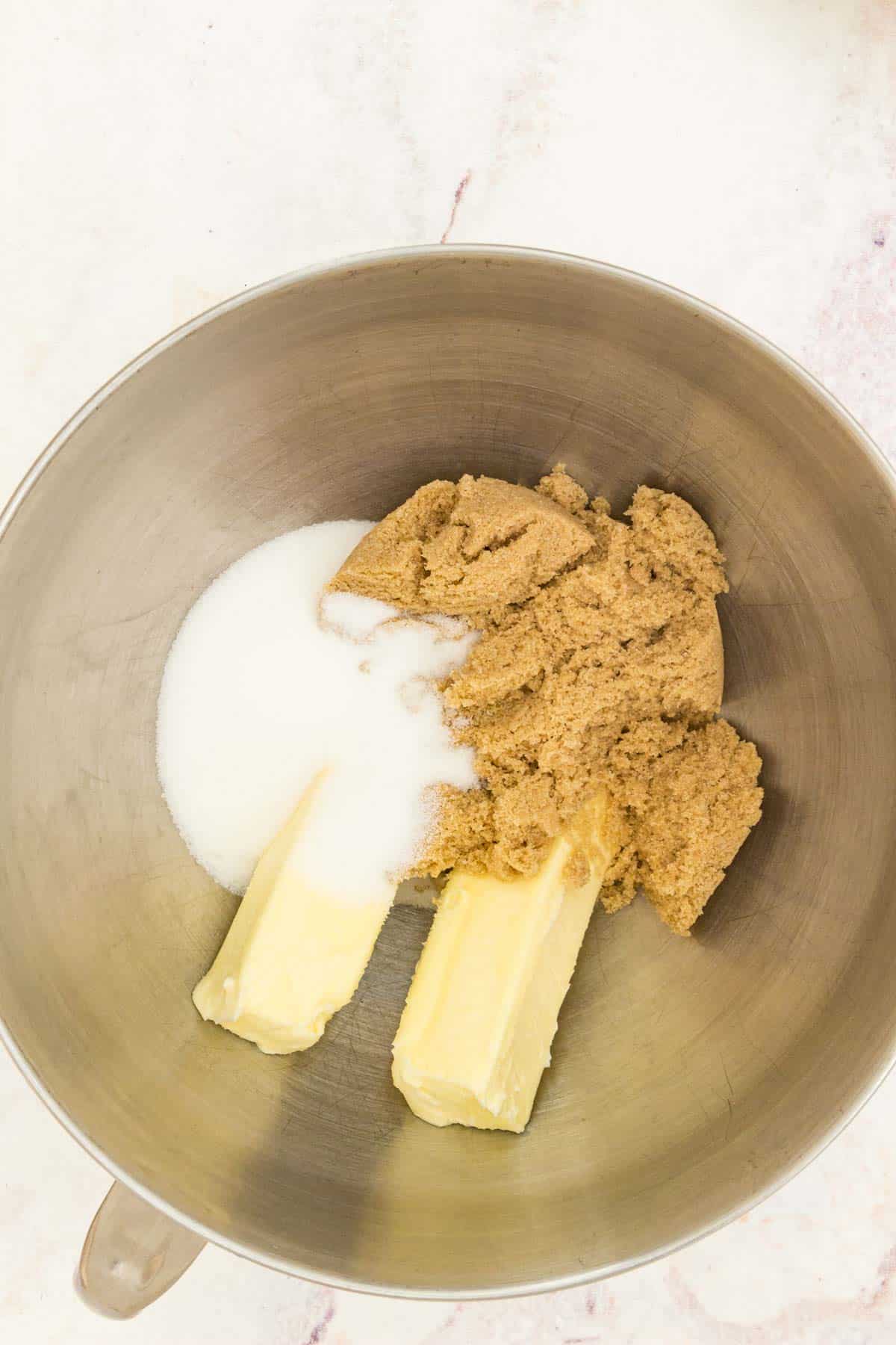 Butter and sugars combined in a mixing bowl.