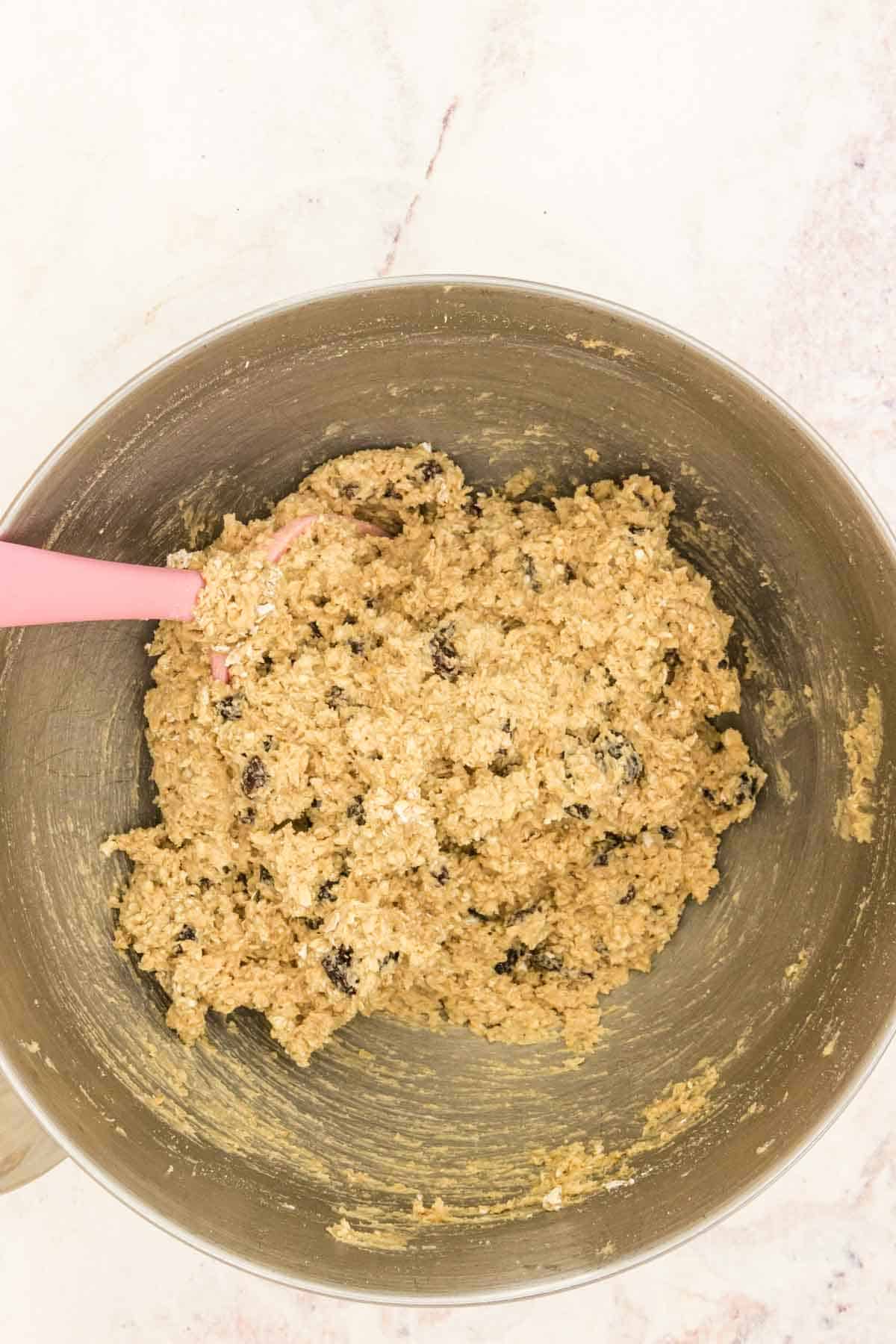 Gluten-free oatmeal raisin cookie dough in a mixing bowl.