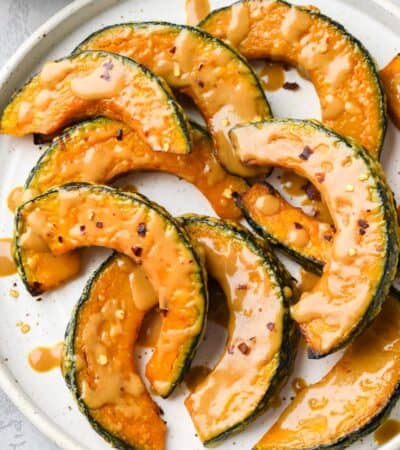 Roasted Kabocha Squash on a plate drizzled with with Miso Glaze