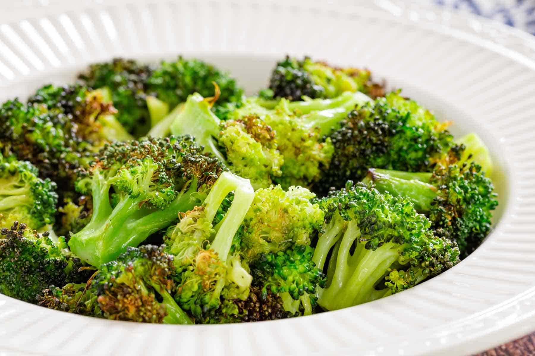 Air fryer broccoli in a white bowl.