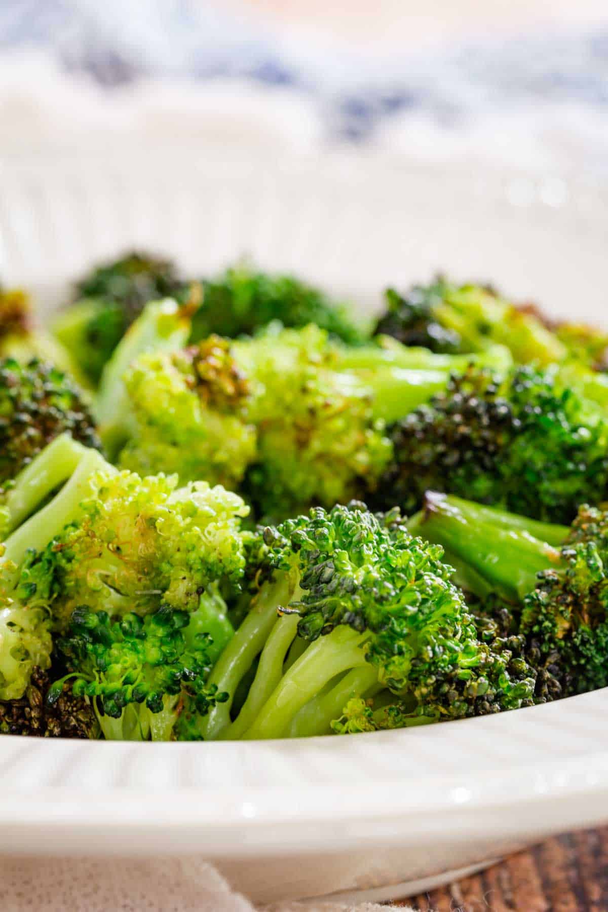 Air fryer broccoli in a white bowl.