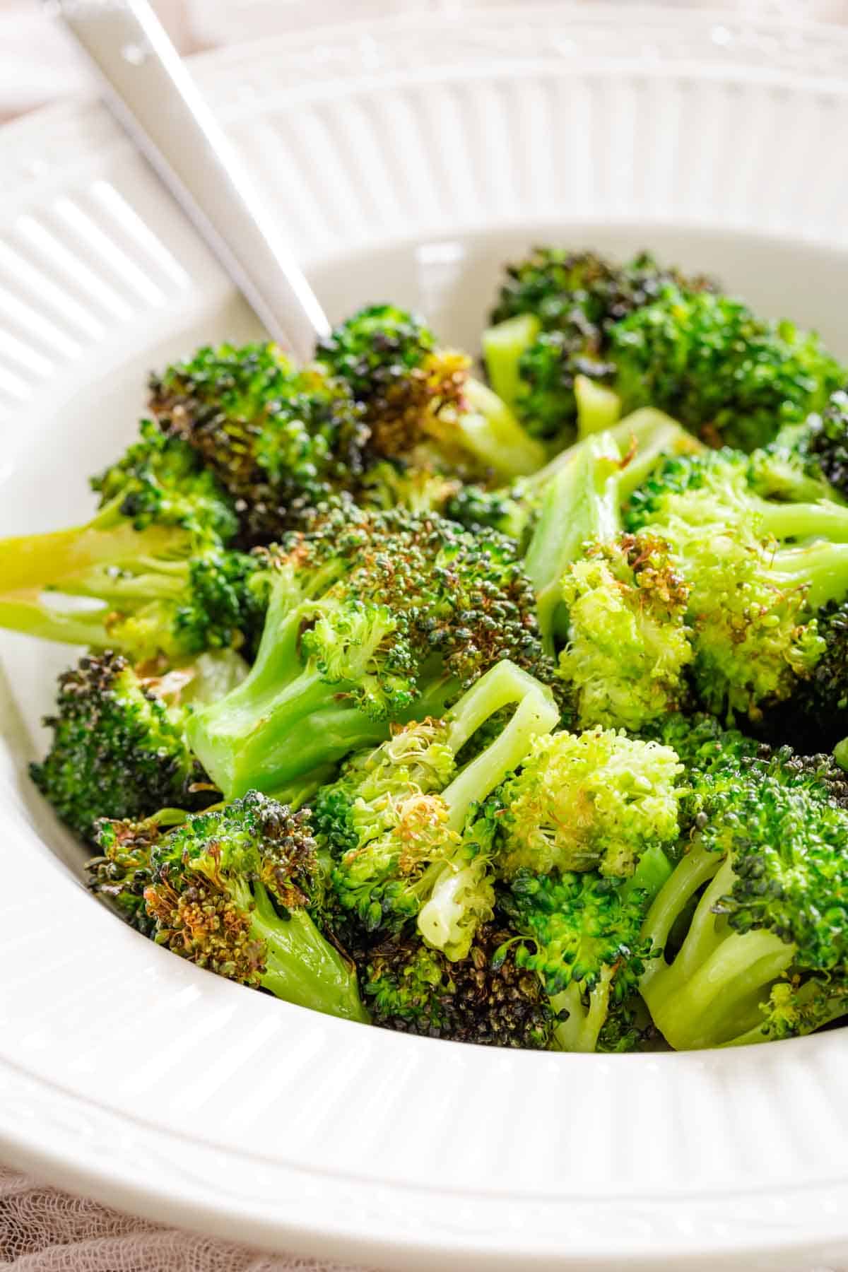 Air fryer broccoli in a white bowl.