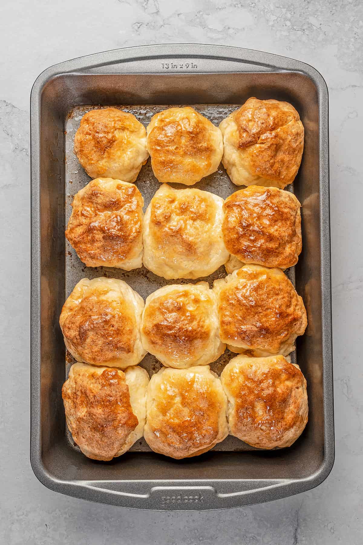 Baked gluten-free Hawaiian rolls on a baking sheet.