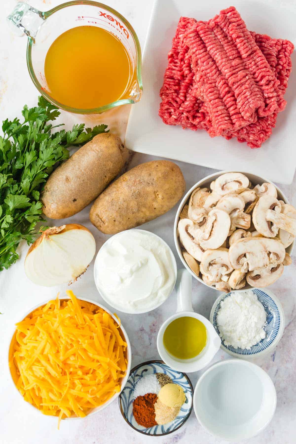 Ingredients to make the ground beef and potatoes skillet meal on a countertop.