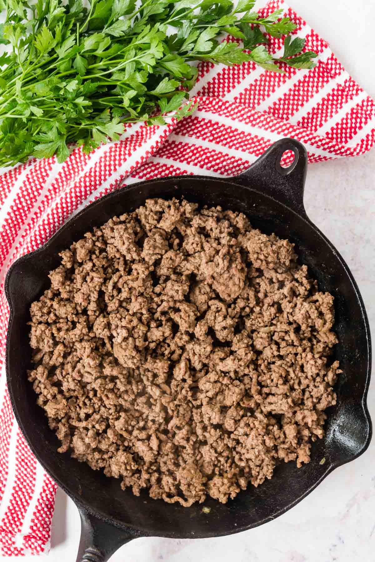 Browned ground beef in a cast iron skillet.