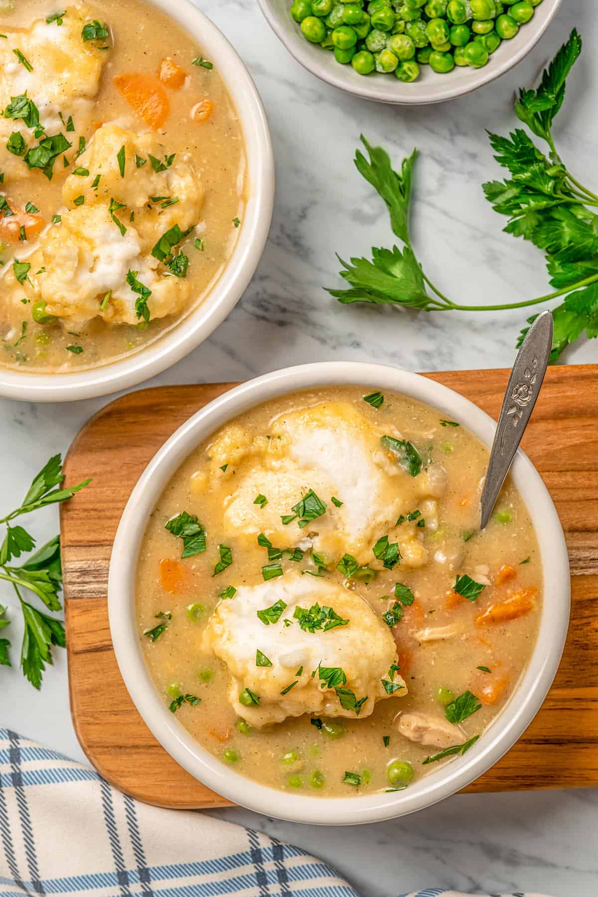 Overhead view of two bowls of gluten-free chicken and dumpling soup.