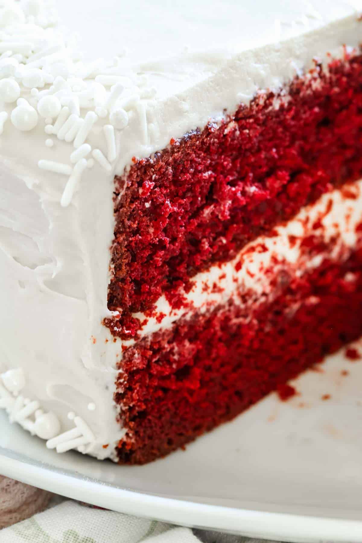 Close up of a two-layer gluten-free red velvet cake frosted with cream cheese frosting.