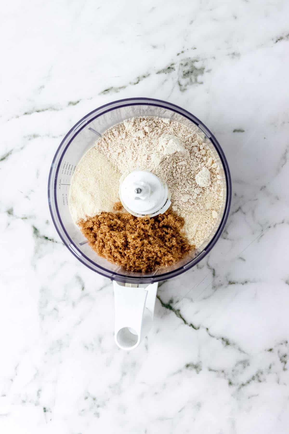 Dry ingredients combined inside a food processor.