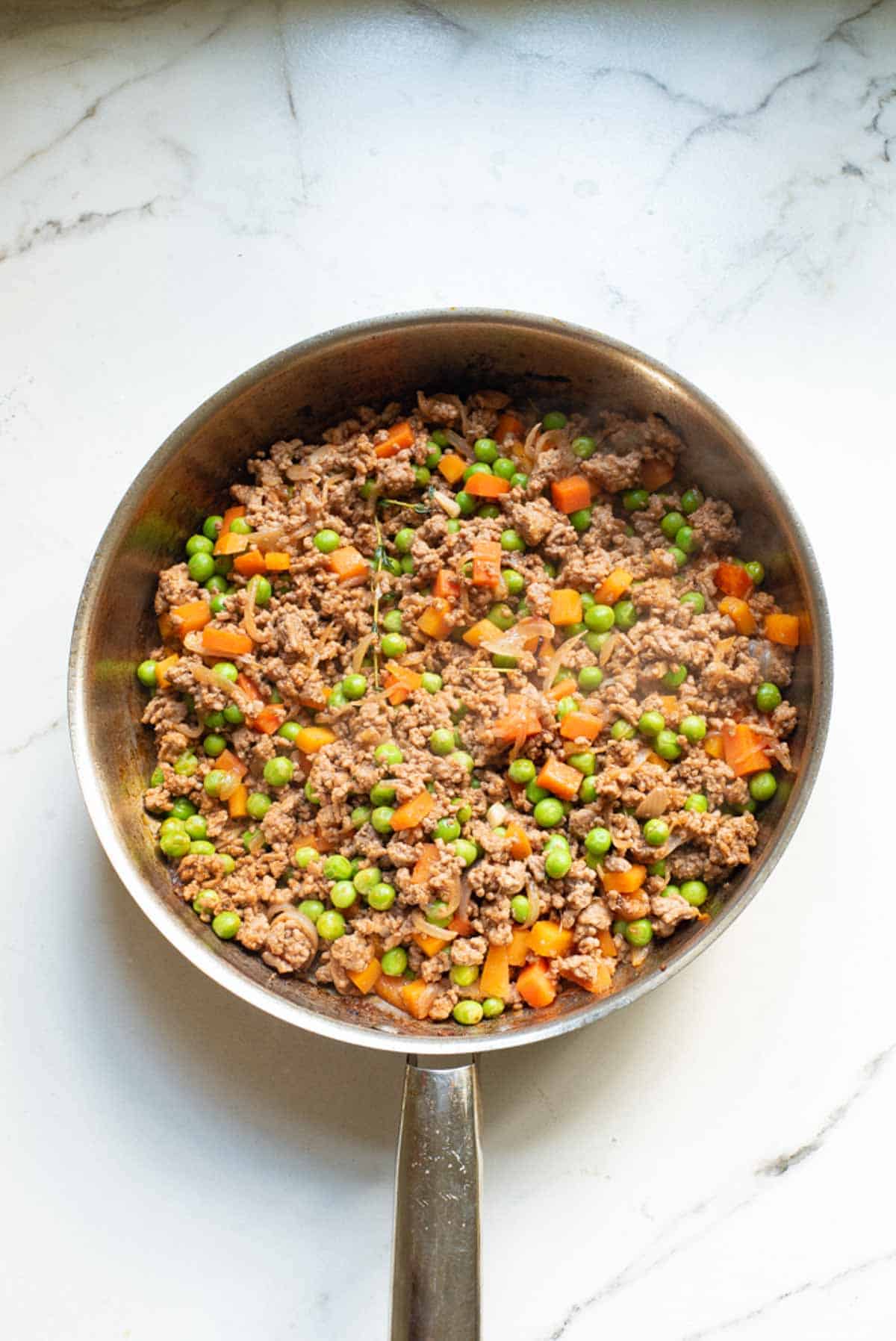 Ground beef filling for shepherd's pie in a large skillet.