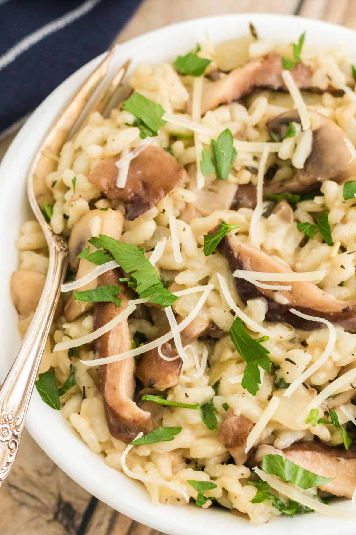 A bowl of mushroom risotto with a spoon.