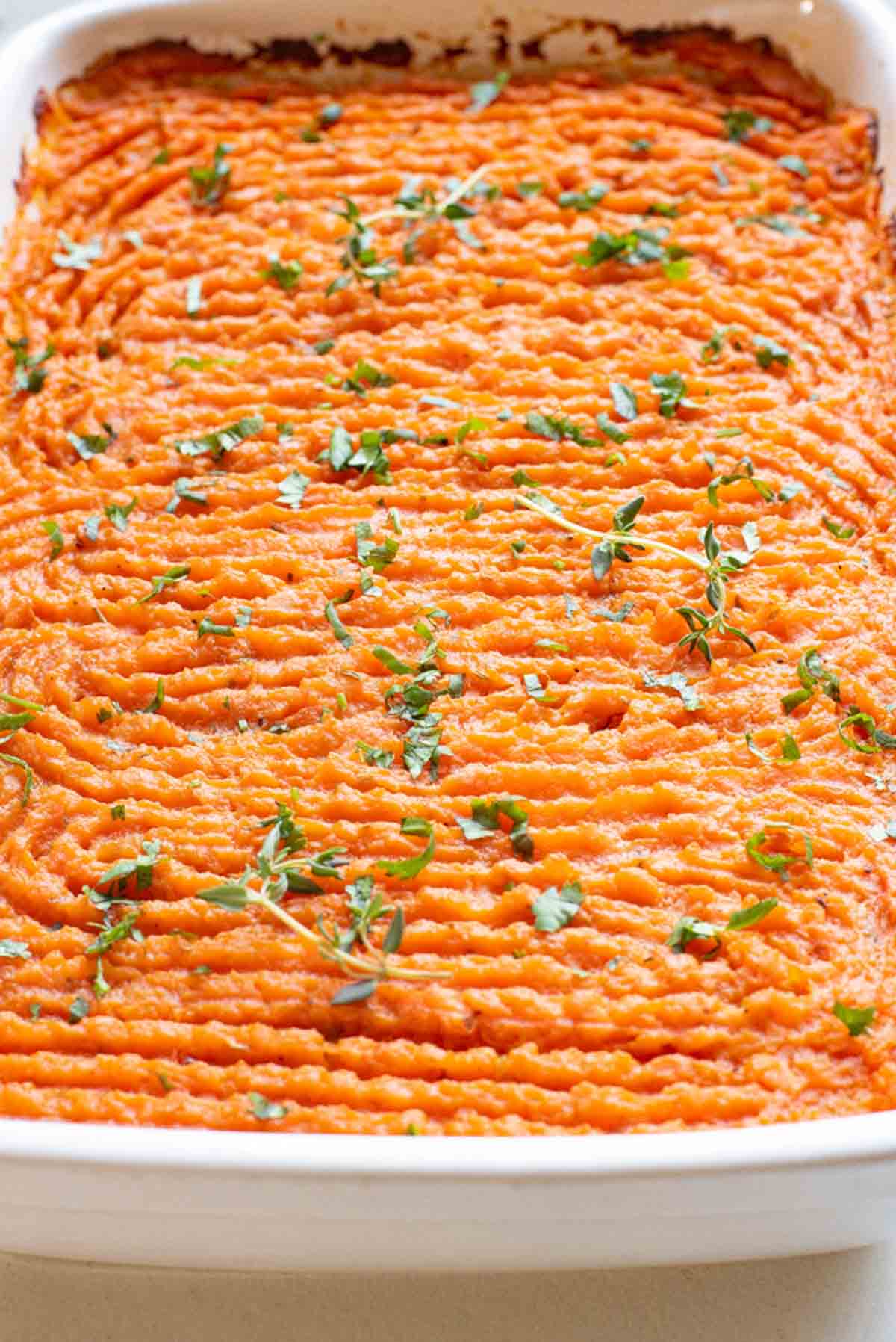 Baked sweet potato shepherd's pie garnished with parsley.