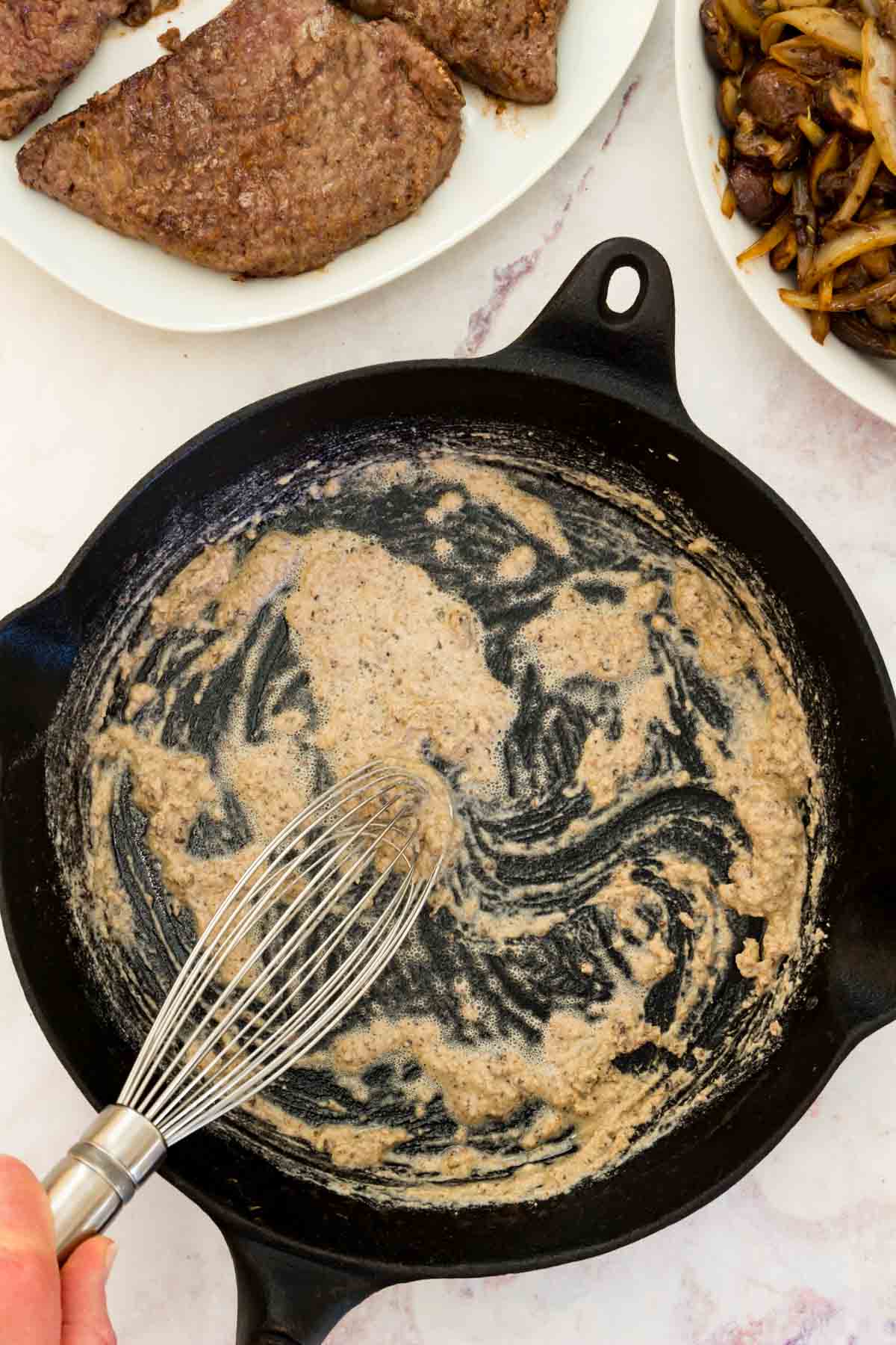 Sweet rice flour is whisked together with melted butter in a skillet.