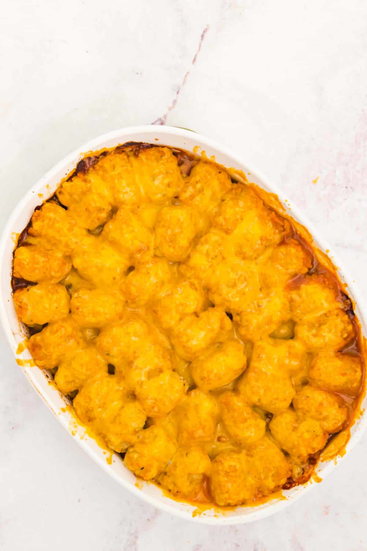 Overhead view of baked tater tot shepherd's pie covered with melted cheese.