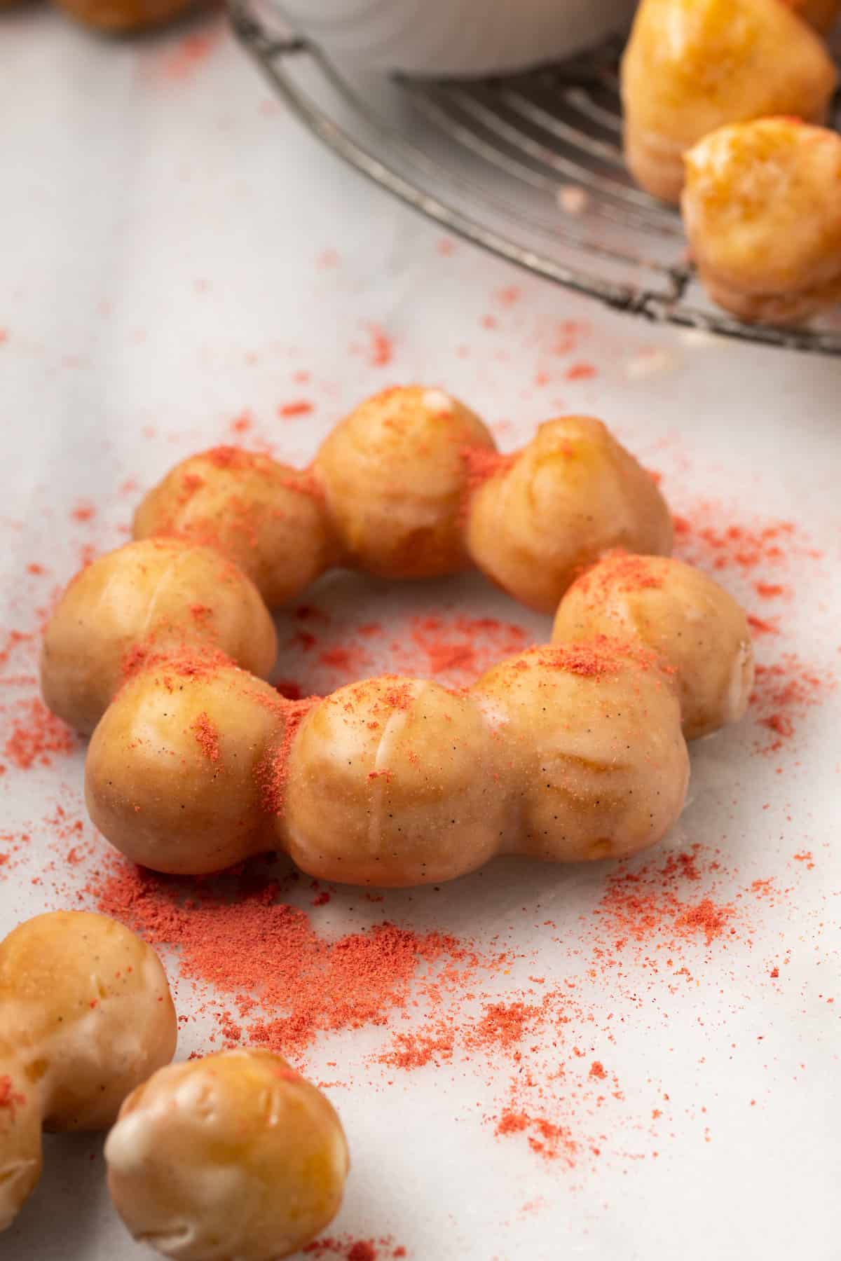 Crushed freeze-dried fruit powder sprinkled over a mochi donut.