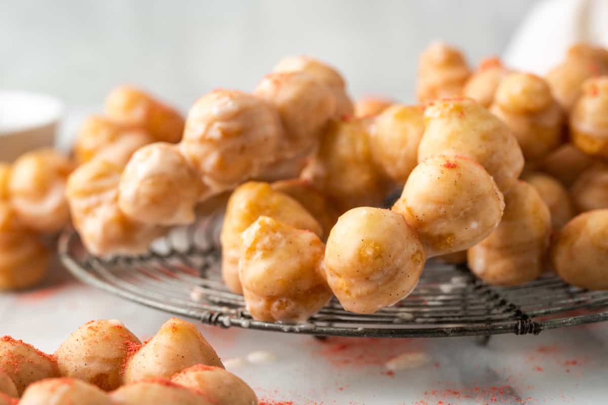 Gluten-free mochi donuts on a wire rack.