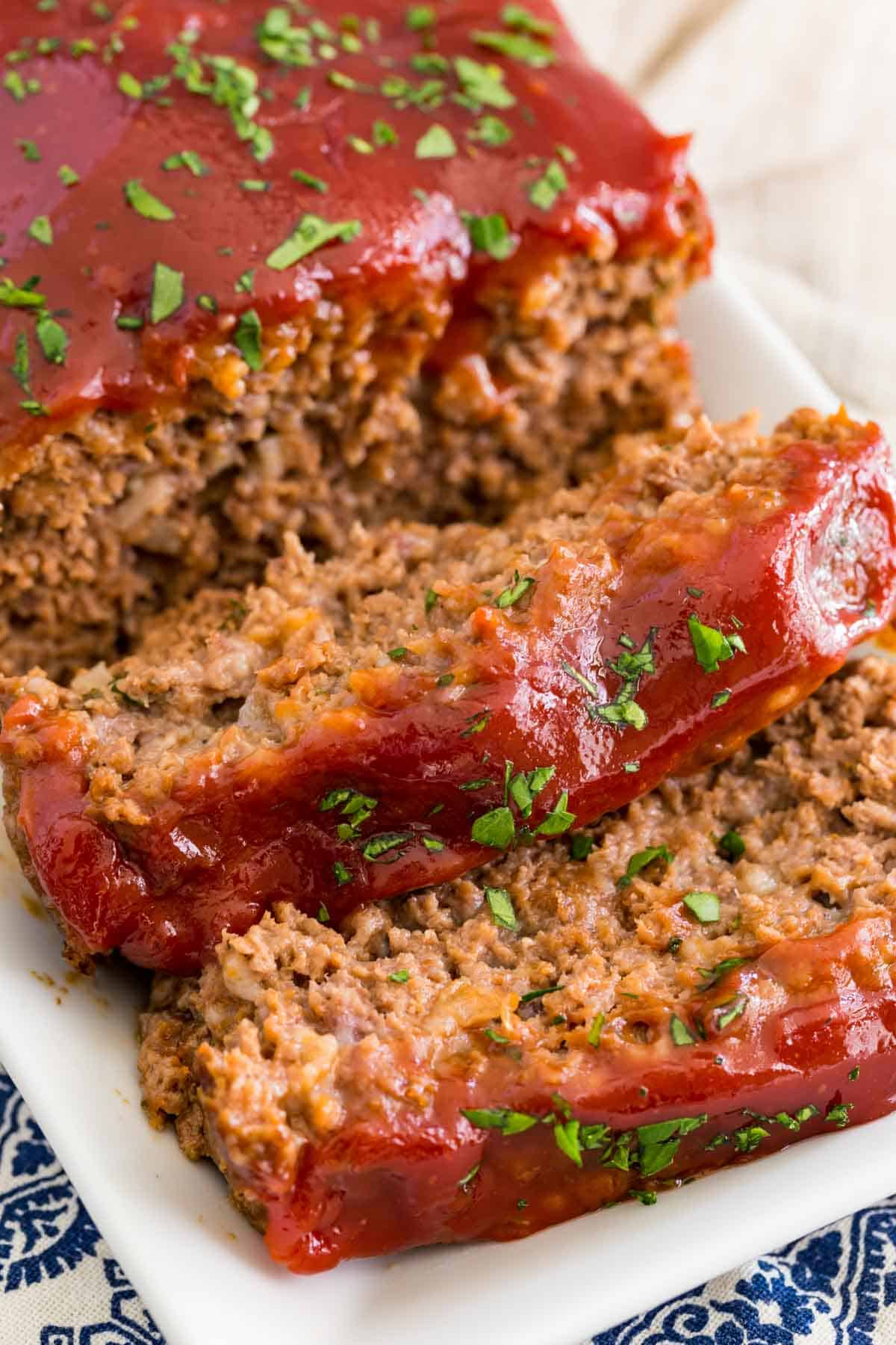 Close up of gluten-free classic meatloaf on a plate, cut into slices.